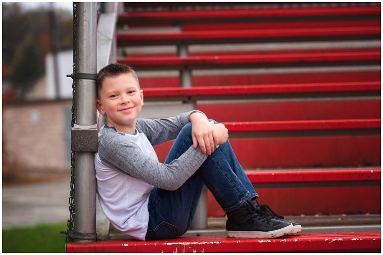 Pittsburgh boy child portrait session on bleachers at baseball field