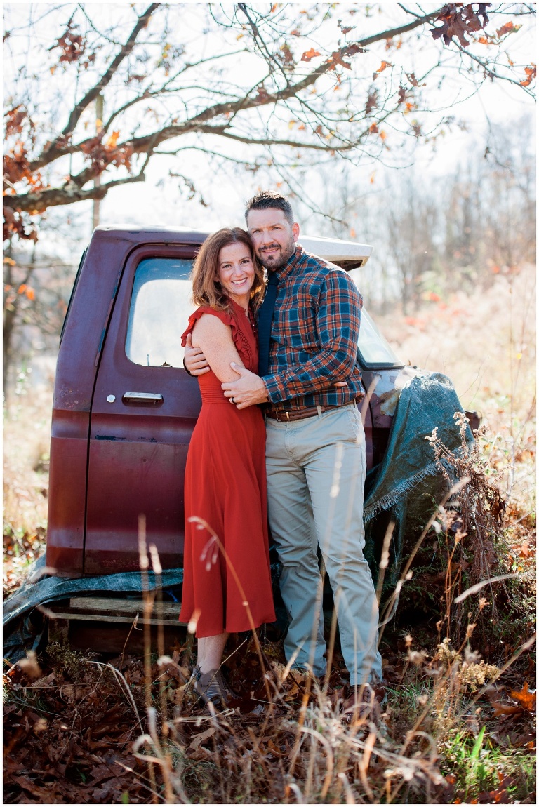 fall family session on farm in tall grass by old truck