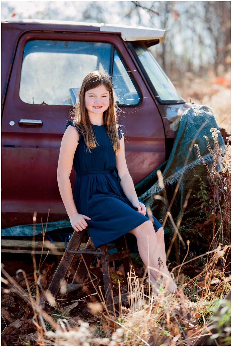 fall family session on farm in tall grass by old truck