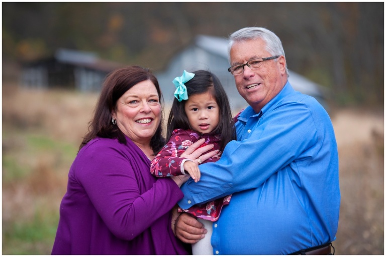fall family session on farm in tall grass